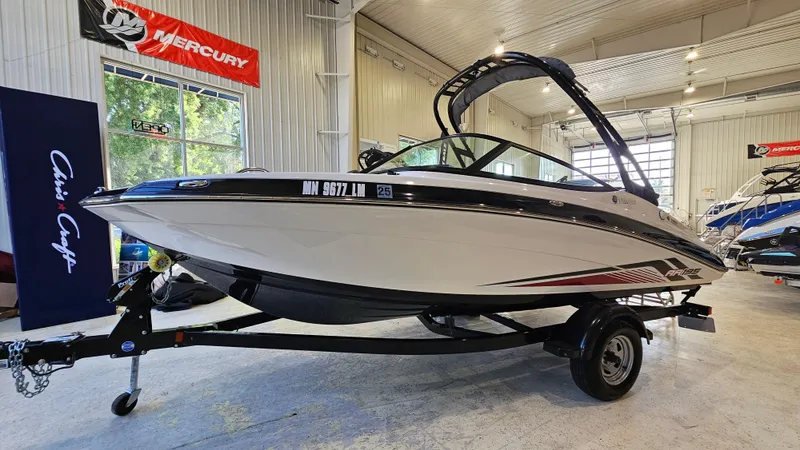 Slide: The Image of 2017 Yamaha Boats AR195 in showroom, on trailer, with sleek design and modern features. - 1