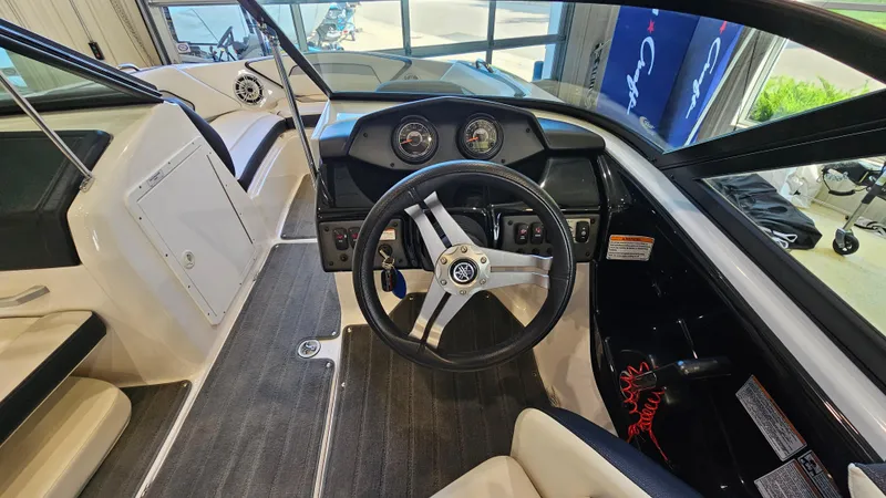 Slide: The Image of 2017 Yamaha Boats AR195 cockpit with steering wheel and dashboard controls. - 13