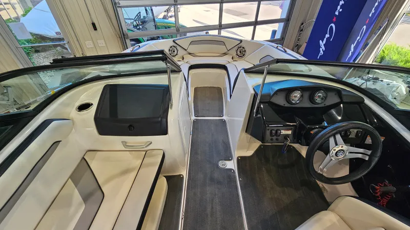 Slide: The Image of 2017 Yamaha Boats AR195 interior with steering wheel, dashboard, and seating in a showroom. - 14