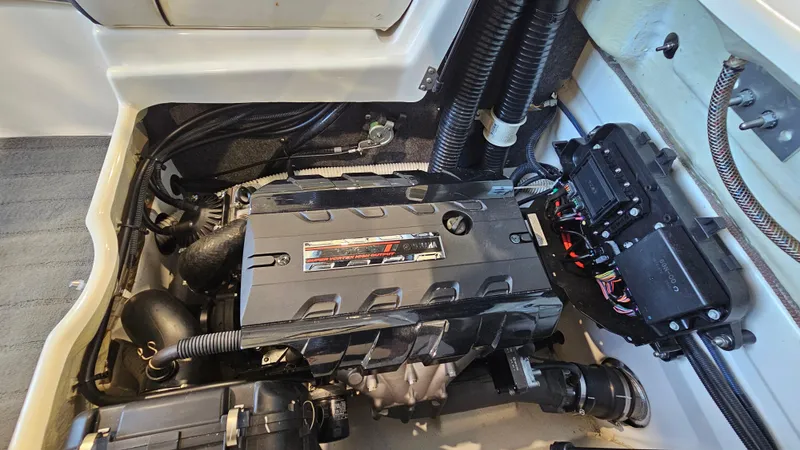 Slide: The Image of Engine compartment of a 2017 Yamaha Boats AR195, showcasing detailed components and wiring. - 22