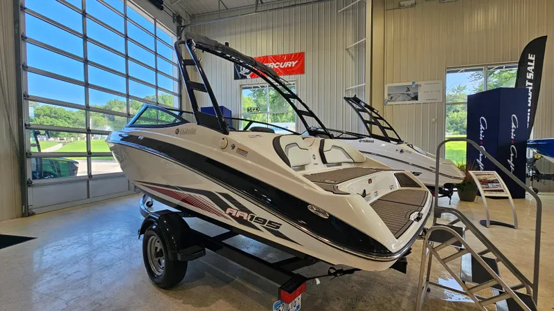 Slide: The Image of 2017 Yamaha AR195 boat displayed in a showroom with large windows. - 4