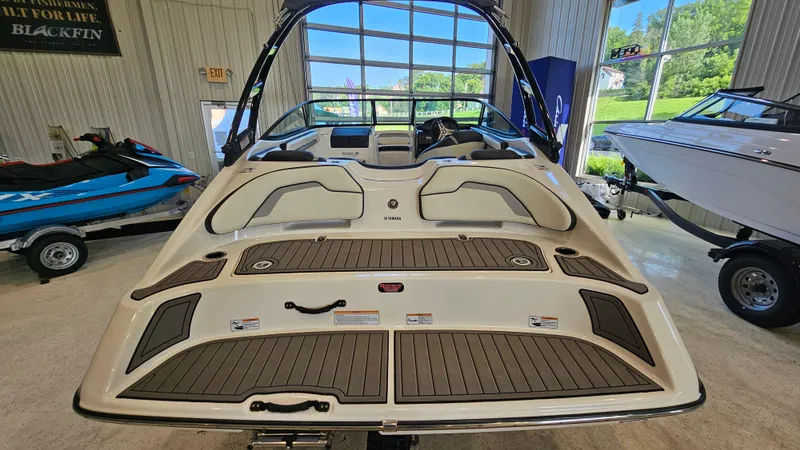 Slide: The Image of 2017 Yamaha Boats AR195 in showroom, rear view with sleek design and spacious interior. - 5