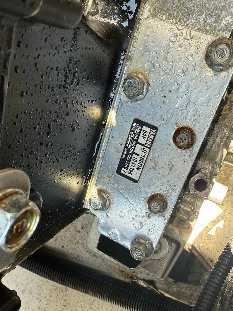 Slide: The Image of Close-up of a 2016 Yamaha Boats 212X engine component with visible bolts and label. - 13