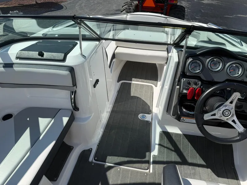 Slide: The Image of 2016 Yamaha Boats 212X interior with steering wheel, dashboard, and seating area. - 15