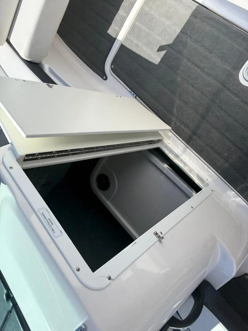 Slide: The Image of Open storage compartment on a 2016 Yamaha Boats 212X. - 17