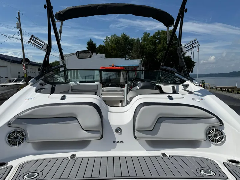 Slide: The Image of 2016 Yamaha Boats 212X with sleek design and spacious seating, docked by the water. - 3