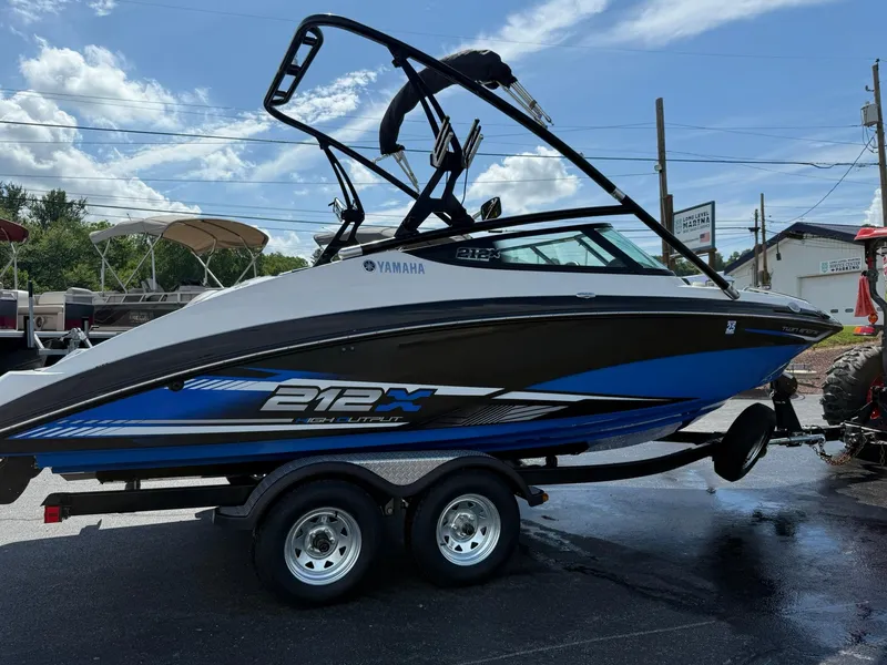Slide: The Image of 2016 Yamaha Boats 212X on trailer under blue sky. - 4
