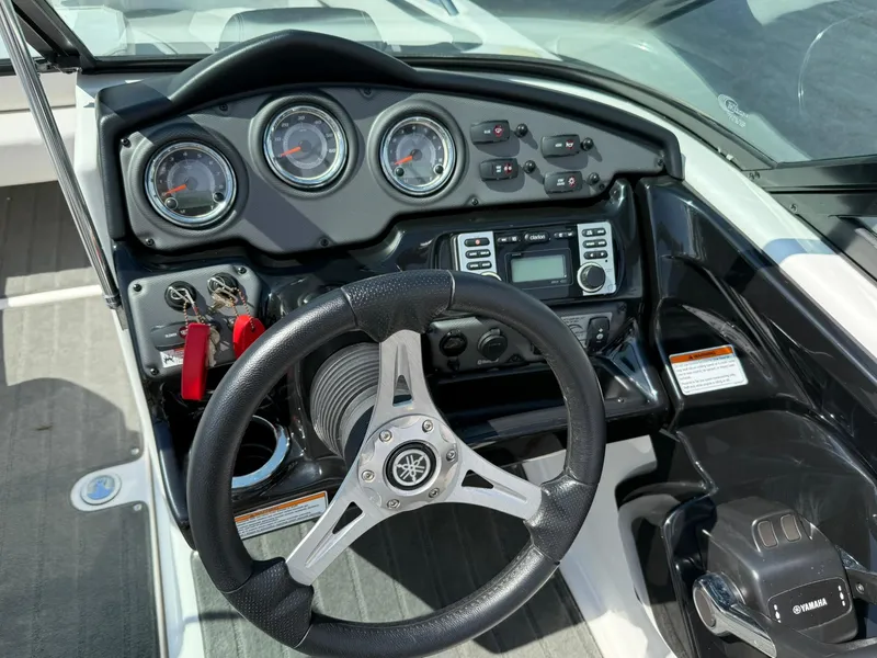 Slide: The Image of 2016 Yamaha Boats 212X dashboard with steering wheel, gauges, and control panel. - 9
