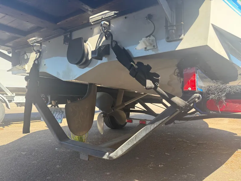 Slide: The Image of 1991 Correct Craft Ski Nautique 196 boat on trailer, showing propeller and rear details. - 10