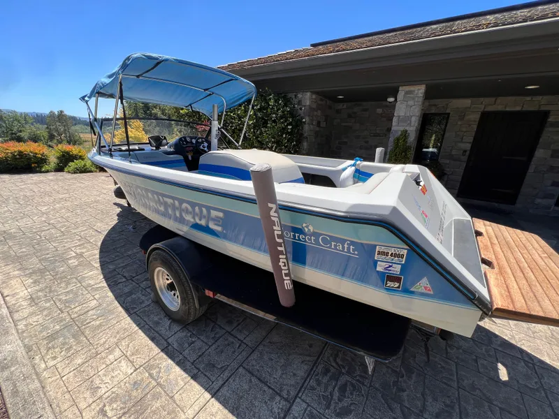 Slide: The Image of 1991 Correct Craft Ski Nautique 196 boat on trailer, parked in driveway. - 11