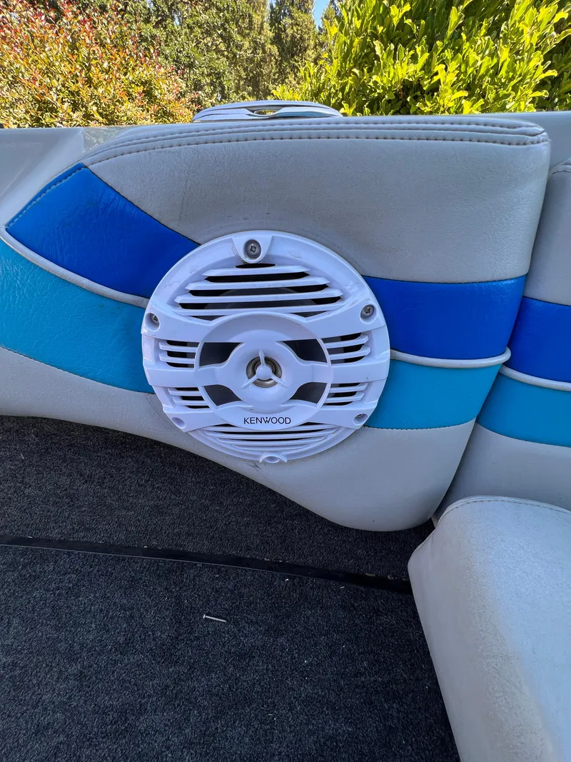 Slide: The Image of Kenwood speaker on 1991 Correct Craft Ski Nautique 196 boat interior with blue accents. - 12