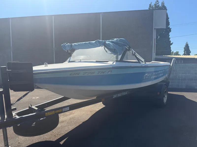 Slide: The Image of 1991 Correct Craft Ski Nautique 196 boat on trailer, parked outdoors. - 5