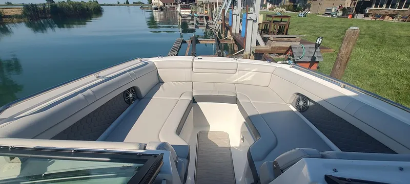 Slide: The Image of 2023 Sea Ray SDX 270 boat interior with spacious seating and waterfront view. - 10