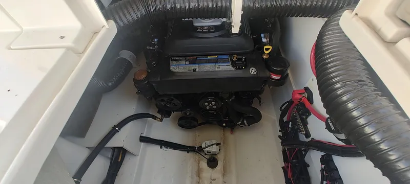 Slide: The Image of Engine compartment of 2023 Sea Ray SDX 270 boat, showcasing mechanical components and wiring. - 11