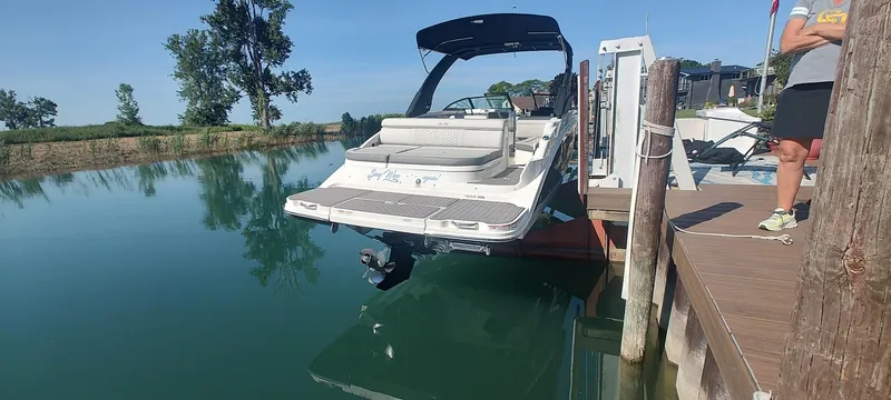 Slide: The Image of 2023 Sea Ray SDX 270 boat docked on calm water, sunny day. - 4