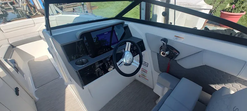 Slide: The Image of Interior view of 2023 Sea Ray SDX 270 boat cockpit with modern controls and seating. - 7