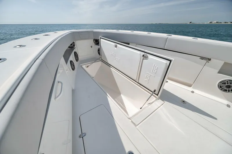 Slide: The Image of 2020 SeaVee 39 boat deck with open storage compartment, ocean view. - 20