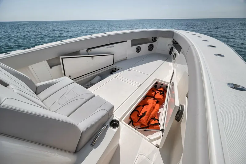 Slide: The Image of 2020 SeaVee 39 boat interior with seating, storage, and life jackets on open water. - 22