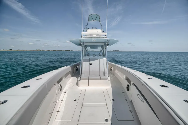 Slide: The Image of 2020 SeaVee 39 boat on open water, clear sky, spacious deck view. - 23