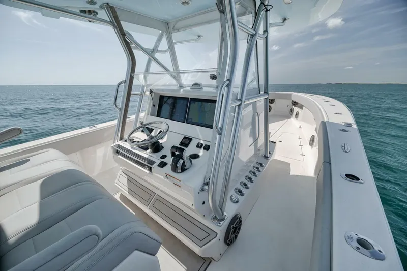 Slide: The Image of 2020 SeaVee 39 boat interior with helm, steering wheel, and ocean view. - 26