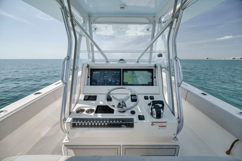 Slide: The Image of 2020 SeaVee 39 boat helm with navigation screens on open water. - 29