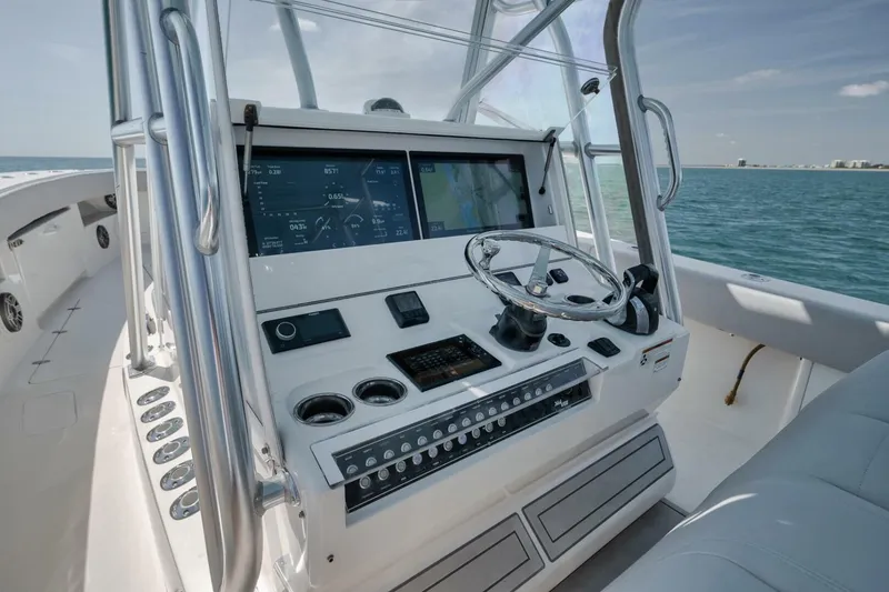 Slide: The Image of 2020 SeaVee 39 boat dashboard with modern navigation controls on open water. - 30
