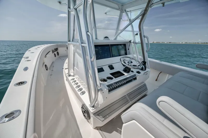 Slide: The Image of 2020 SeaVee 39 boat cockpit with modern controls, steering wheel, and ocean view. - 31
