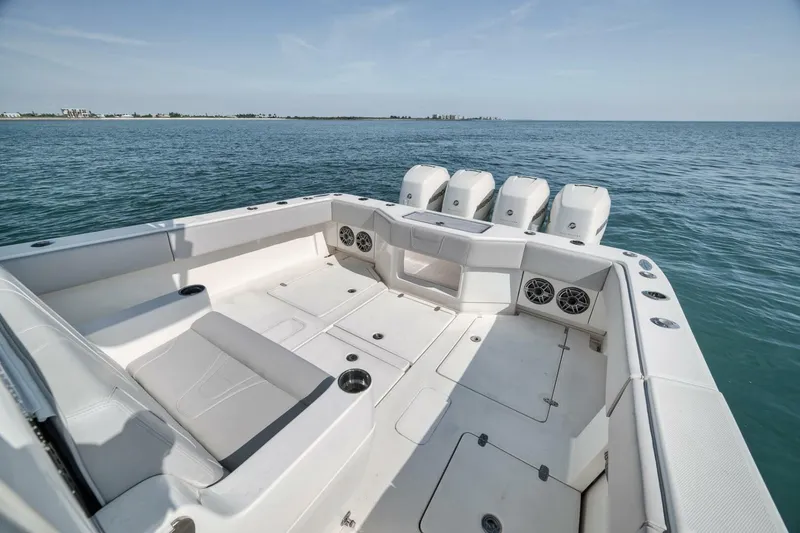 Slide: The Image of 2020 SeaVee 39 boat with spacious deck and four powerful outboard engines on open water. - 32
