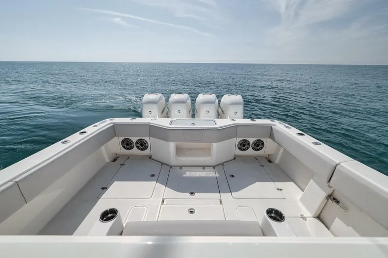Slide: The Image of 2020 SeaVee 39 boat deck with quad engines, overlooking calm ocean waters. - 33
