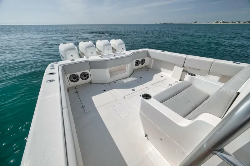 Slide: The Image of 2020 SeaVee 39 boat deck with seating, ocean view, and multiple outboard engines. - 39
