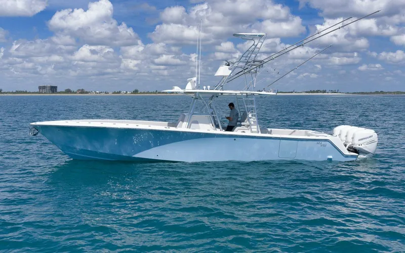 Slide: The Image of 2020 SeaVee 39 boat on calm ocean waters under a partly cloudy sky. - 5