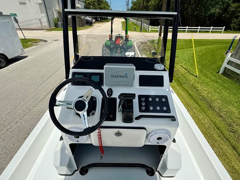 Slide: The Image of 2015 SCB Recon boat console with Garmin navigation, steering wheel, and control panel. - 10