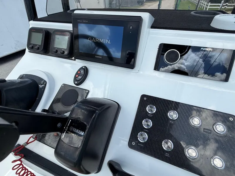 Slide: The Image of Control panel of a 2015 SCB Recon boat with Garmin and Yamaha equipment. - 16