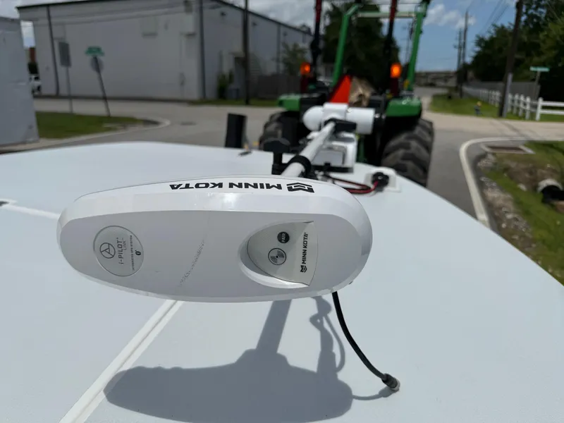 Slide: The Image of Minn Kota motor on SCB Recon 2015 boat, with tractor in background. - 17