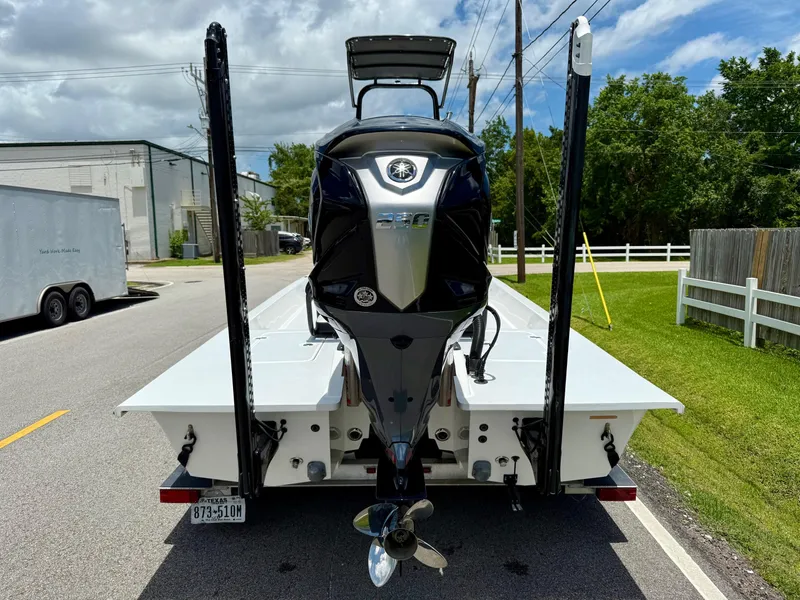 Slide: The Image of 2015 SCB Recon boat with powerful outboard motor on trailer, parked on street. - 3