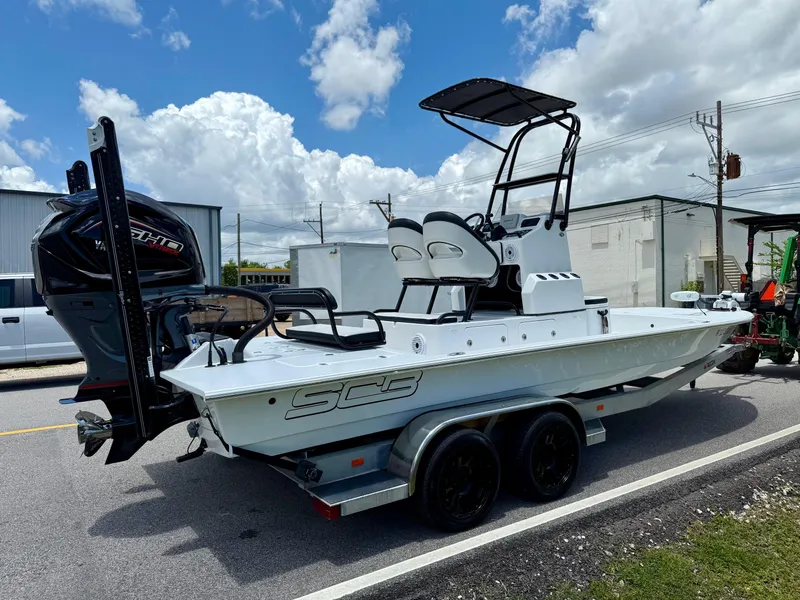 Slide: The Image of 2015 SCB Recon boat on trailer, featuring dual seats and powerful outboard motor. - 4