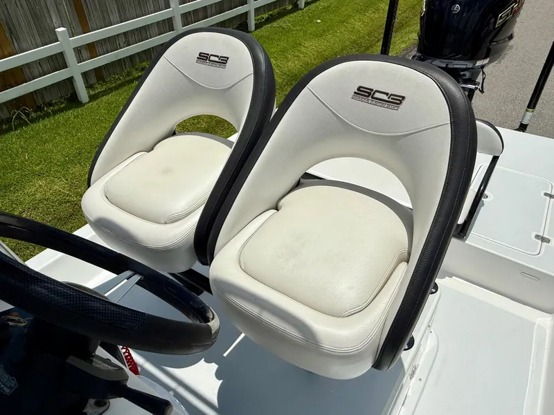 Slide: The Image of White SCB Recon 2015 boat seats with black trim, outdoor setting. - 9