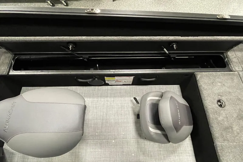 Slide: The Image of 2026 Alumacraft Competitor 175X Tiller interior with seating and storage compartments. - 11