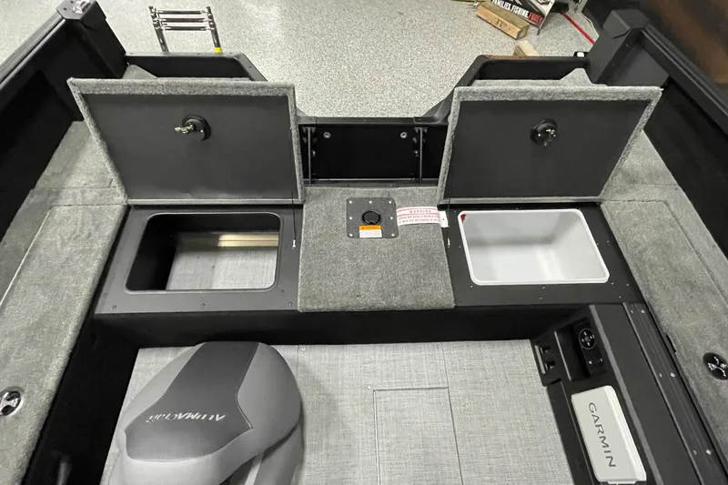 Slide: The Image of 2026 Alumacraft Competitor 175X Tiller boat interior with storage compartments and Garmin equipment. - 12
