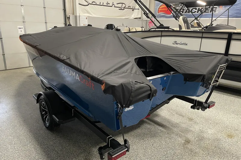 Slide: The Image of 2026 Alumacraft Competitor 175X Tiller boat with cover in showroom. - 16