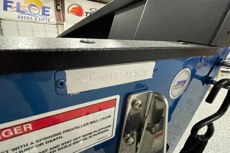 Slide: The Image of 2026 Alumacraft Competitor 175X Tiller boat with identification plate and safety warning. - 17