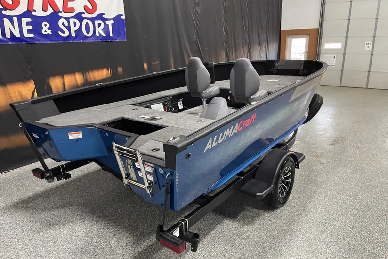 Slide: The Image of 2026 Alumacraft Competitor 175X Tiller boat on display in showroom. - 2