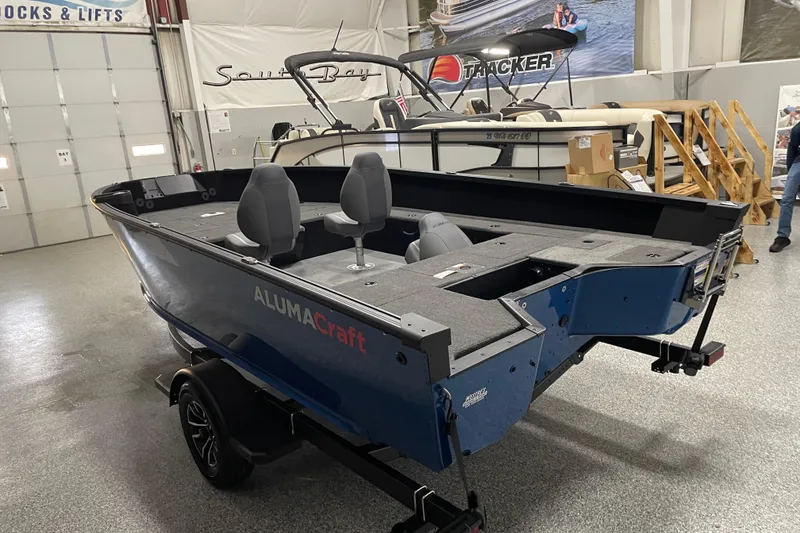 Slide: The Image of 2026 Alumacraft Competitor 175X Tiller boat in showroom, featuring sleek design and dual seating. - 3