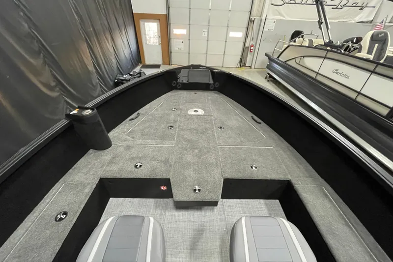 Slide: The Image of 2026 Alumacraft Competitor 175X Tiller boat interior with gray seating and spacious deck. - 4