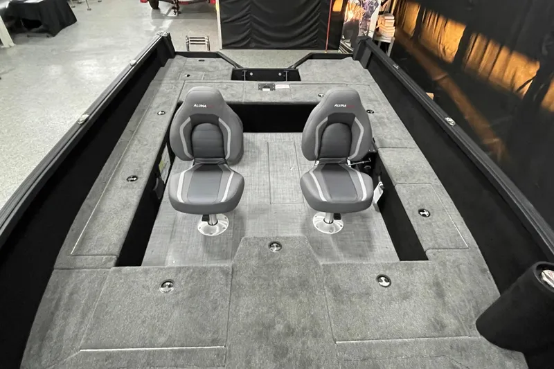 Slide: The Image of 2026 Alumacraft Competitor 175X Tiller boat interior with two seats and carpeted deck. - 5