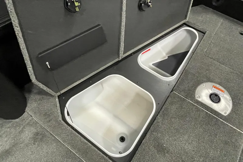 Slide: The Image of 2026 Alumacraft Competitor 175X Tiller boat storage compartments, open and empty. - 7
