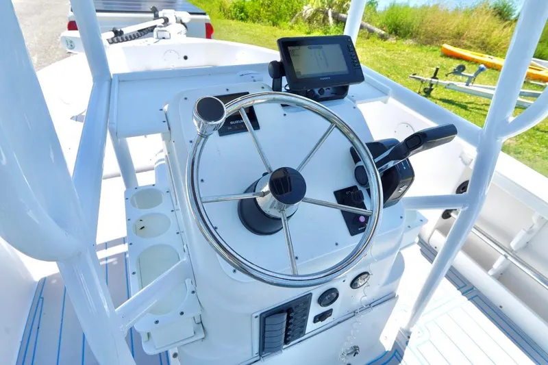 Slide: The Image of 2003 Key Largo 186 CC boat console with steering wheel and navigation equipment. - 13
