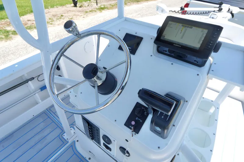 Slide: The Image of 2003 Key Largo 186 CC boat console with steering wheel and navigation system. - 14