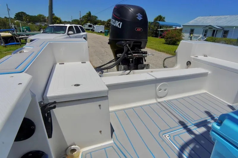 Slide: The Image of 2003 Key Largo 186 CC boat with Suzuki outboard motor, parked outdoors. - 22