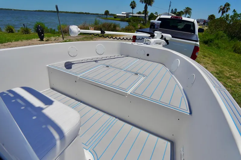 Slide: The Image of 2003 Key Largo 186 CC boat with seating, near a lake and parked truck. - 4